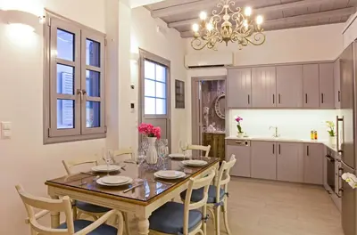 a kitchen and dining room with a table and chairs at Lindos Shore Boutique Villa with sea view in Líndos