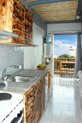 a kitchen with a sink and a view of a porch at Christos studios and family apartments in Rhodes Town