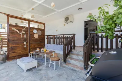 a living room with a couch and a table at Christos studios and family apartments in Rhodes Town