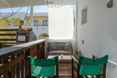 a balcony with two chairs and a table and a chair at Christos studios and family apartments in Rhodes Town