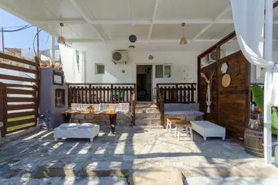 a patio with a table and chairs on a house at Christos studios and family apartments in Rhodes Town