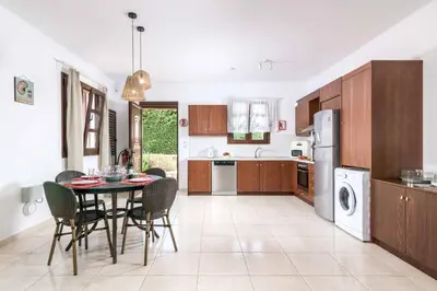 a kitchen and dining room with a table and chairs at Lindos Ruby in Líndos