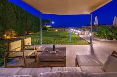 a patio with a couch and chairs and a table at Lindos Topaz in Líndos