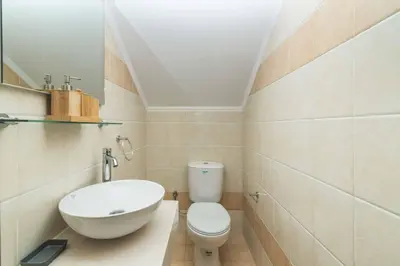 a bathroom with a white toilet and a sink at Lindos Topaz in Líndos
