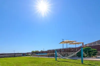 a playground with a slide and an umbrella at Lindos Topaz in Líndos