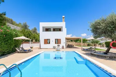 a villa with a swimming pool and a house at Villa Krini Selini in vlicha