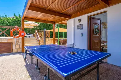 a blue ping pong table in front of a patio at Lindos Emerald in Líndos