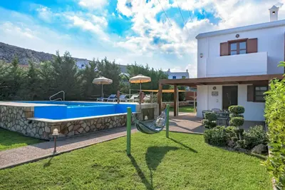 a villa with a swimming pool and a house at Lindos Emerald in Líndos