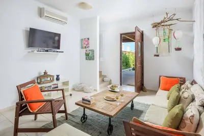 a living room with a couch and a table at Lindos Emerald in Líndos