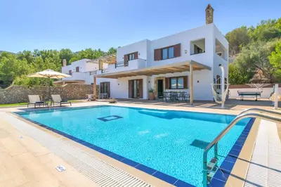 a villa with a swimming pool in front of a house at Villa Krini Eleni in vlicha