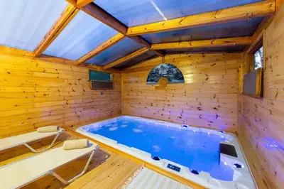 a hot tub in a wooden room with a ceiling at Nicole's garden villa in Kallithea Rhodes