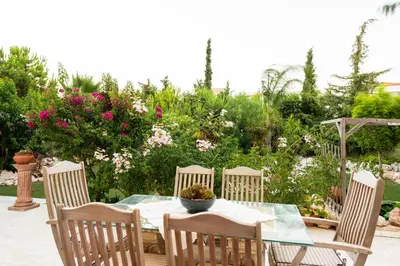 a table with four chairs and a bowl on it at Nicole's garden villa in Kallithea Rhodes