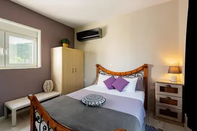 a bedroom with a bed and a window at Nicole's garden villa in Kallithea Rhodes
