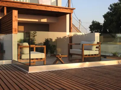 a deck with two chairs and a table on a building at Nikos Ikies in Theologos