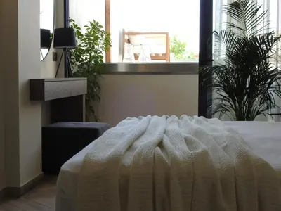 a bedroom with a bed with a white blanket at Nikos Ikies in Theologos