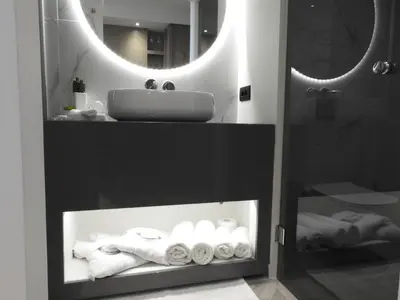 a bathroom with a sink and a mirror and towels at Nikos Ikies in Theologos