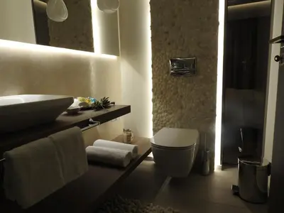 a bathroom with a sink and a toilet and a mirror at Nikos Ikies in Theologos