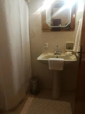 a bathroom with a sink and a mirror at Nikos Ikies in Theologos