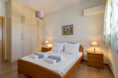a bedroom with a bed with towels on it at Alav Pool Villa in Afantou