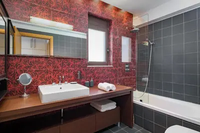 a bathroom with a sink and a mirror and a tub at Alav Pool Villa in Afantou