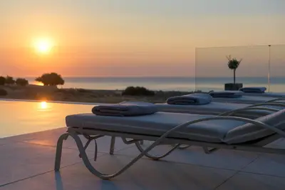 a row of mattresses sitting on top of a swimming pool at Alav Pool Villa in Afantou