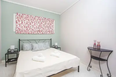 a bedroom with a bed with two towels on it at Flora's Place in Rhodes Town