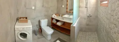 a bathroom with a toilet and a sink and a shower at Casa Kalliroi in Symi