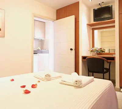 a hotel room with a bed with roses on it at Hotel Galaxias in Rhodes Town