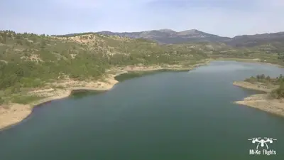 an aerial view of a lake with mountains in the background at Amaliahotel in Apolakkiá