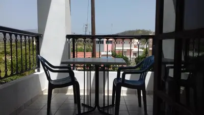 a table and two chairs sitting on a balcony at Amaliahotel in Apolakkiá
