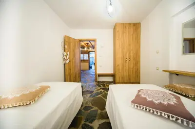 two beds sitting next to each other in a room at Pitropos Garden in Archangelos