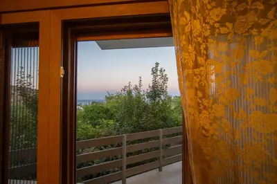 a window view of the ocean from a house at Pitropos Garden in Archangelos