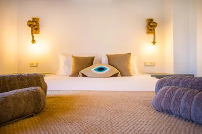 a bedroom with a bed with an eye pillow on it at Pitropos Garden in Archangelos