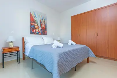 a bedroom with a bed and a wooden cabinet at Central Luxurious Apartments Close to the Sea in Rhodes Town