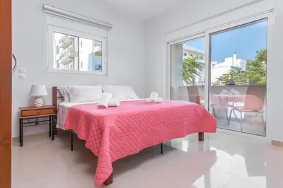 a bedroom with a pink bed with a pink blanket at Central Luxurious Apartments Close to the Sea in Rhodes Town