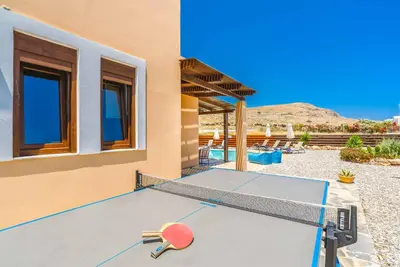 a ping pong table in front of a house at Villa Ophelia in Líndos