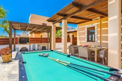 a pool table in front of a house at Villa Ophelia in Líndos