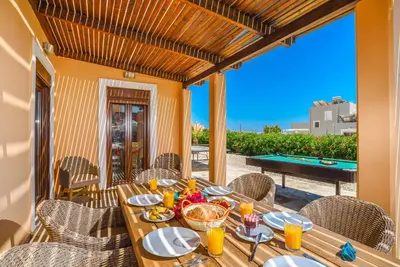 a wooden table with food on top of a patio at Villa Ophelia in Líndos