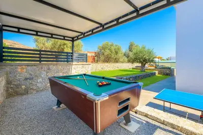 a pool table sitting on a patio with a pool table at Lambis Harmonia in Líndos