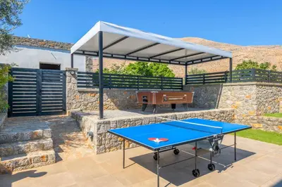 a ping pong table with a canopy on a patio at Lambis Harmonia in Líndos