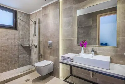 a bathroom with a sink and a toilet and a shower at Lambis Harmonia in Líndos