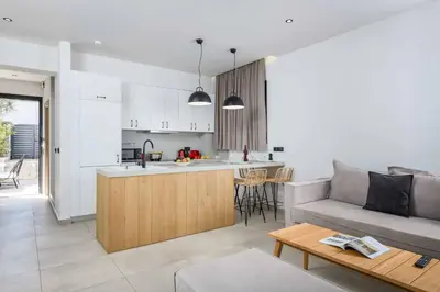 a kitchen and living room with a couch and a table at Lambis Harmonia in Líndos