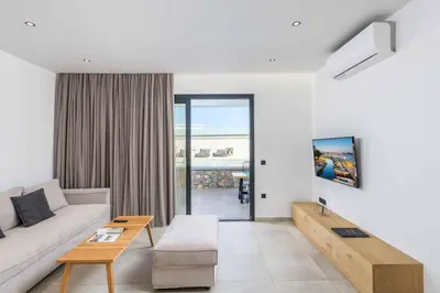 a living room with a couch and a table at Lambis Harmonia in Líndos