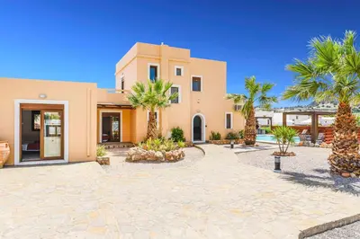a house with palm trees in front of it at Villa Ioanna in Líndos