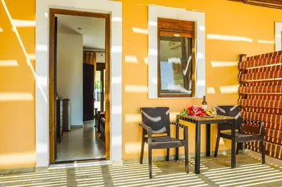 a room with a table and chairs and a mirror at Villa Ioanna in Líndos