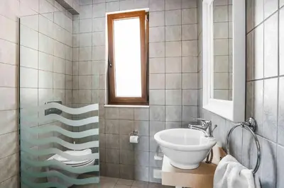 a bathroom with a sink and a toilet in it at Villa Ioanna in Líndos