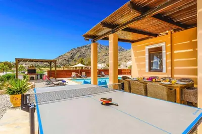 a ping pong table in front of a house at Villa Ioanna in Líndos