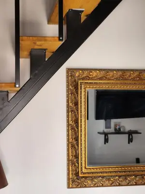 a mirror on a wall next to a staircase with a television at Lindos Boutique - Adults Only in Líndos