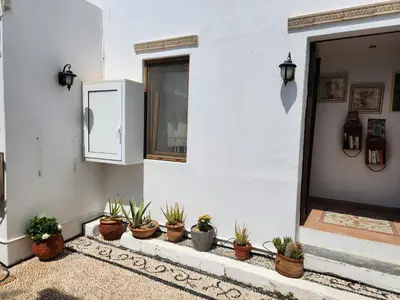 a row of potted plants on the side of a house at Lindos Boutique - Adults Only in Líndos