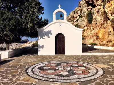 a small white church with a mandala on the ground at Lindos Boutique - Adults Only in Líndos